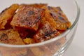 Close-up of charcoal-grilled Chinese bakkwa jerky made from chicken meat, in a glass bowl